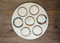 Top view of 7-bracelet design board, featuring a solar-system-themed design.